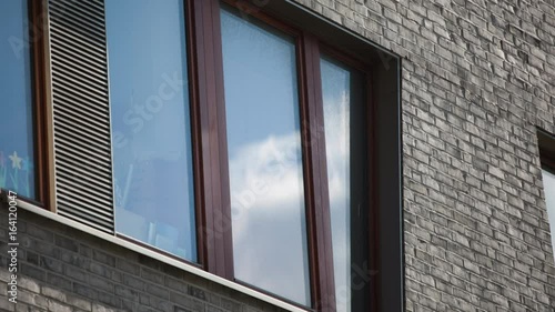 Sky and clouds reflecting off house window in time lapse. 