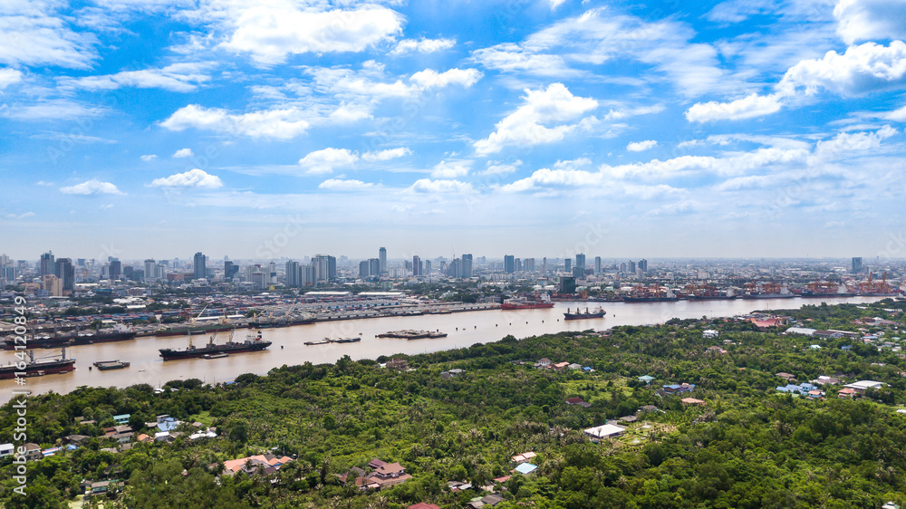 Obraz premium Aerial View of Bangkok skyline and view of Chao Phraya River View from green zone in Bang Krachao, Phra Pradaeng, Samut Prakan Province.