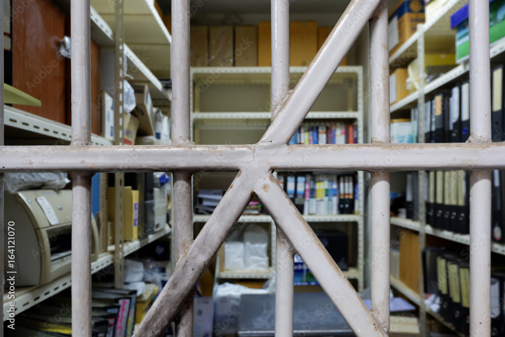 Old folder storage room seen through bars