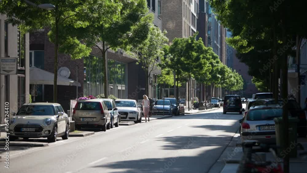 Quiet street in Hamburg, Germany with cars, bicycle riders, and public transportation. Quiet street in Hamburg, Germany with cars, bicycle riders, and public transportation.