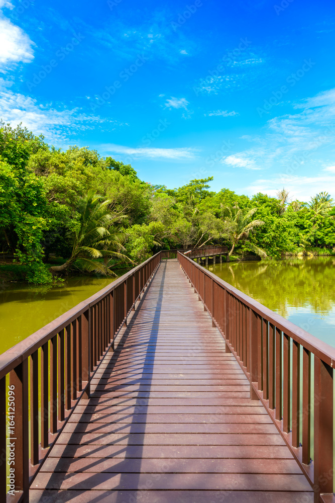Wooden bridge walkway in Sri Nakhon Khuean Khan Park and Botanical Garden