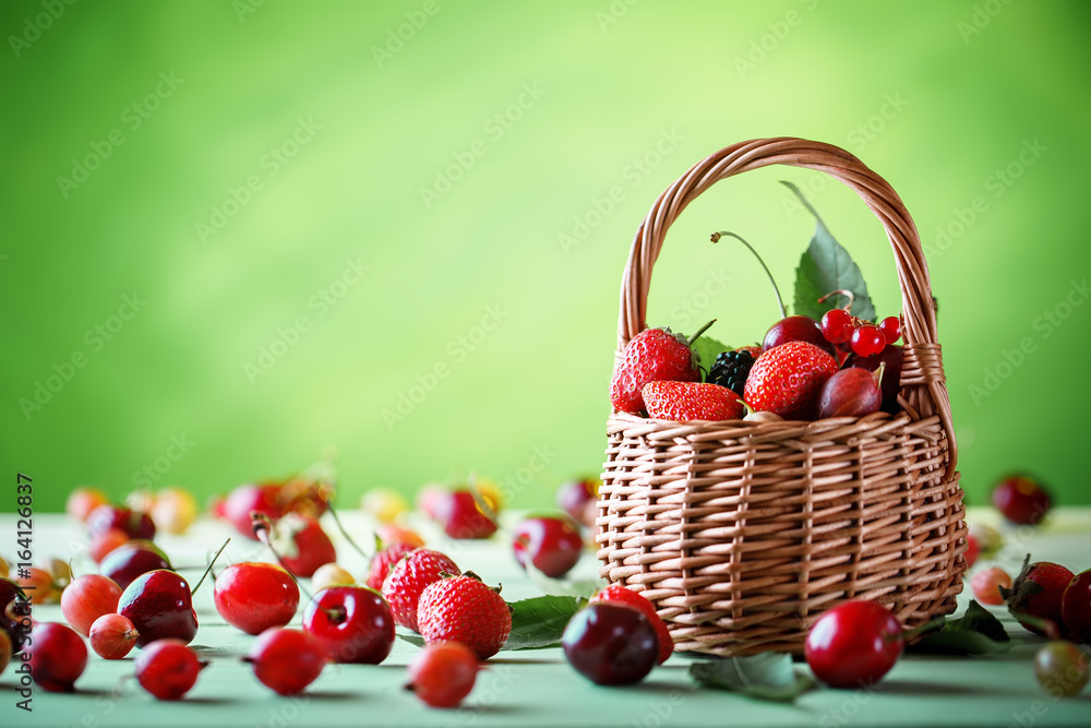 Ripe berries in a wicker basket on a wooden table. Ripe berries in a wicker basket on a wooden table.