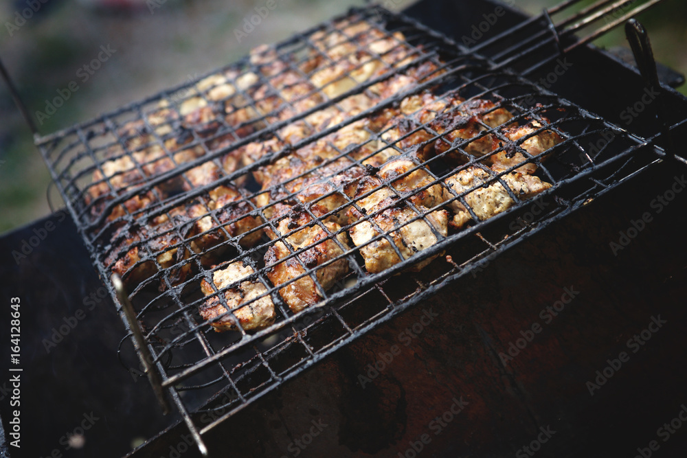 Meat being grilled in a barbecue