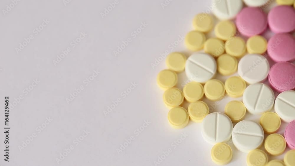 Medical Pills turn on white background. Video close-up top view. Medical Pills turn on white background. Video close-up top view.