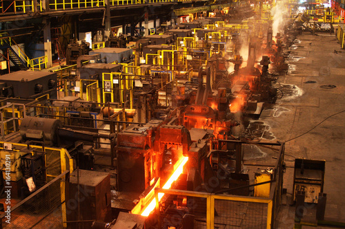 Red hot steel bar in multi stand rolling mill.