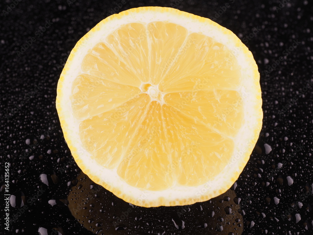 Lemon on a dark background with droplets Lemon on a dark background with droplets