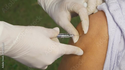 4k video of doctor injecting flu vaccine to patient's arm