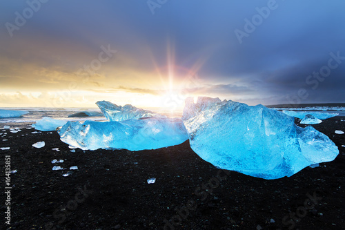 Beautiful beached chunks of ice at the beach at Jokulsarlon, Iceland, at sunset in winter