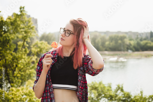 Girl with red hair in sunscreen with lollipop