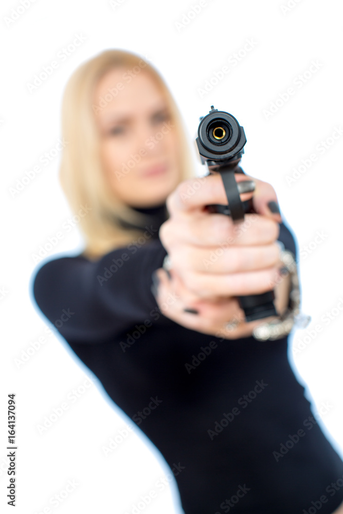 Young blonde woman in a black suit with a gun Young blonde woman in a black suit with a gun