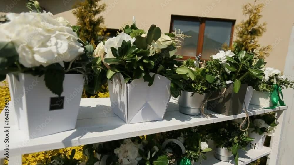 Close up shot of white flowers on the rack for wedding ceremony. Dolly shot. Close up shot of white flowers on the rack for wedding ceremony. Dolly shot.
