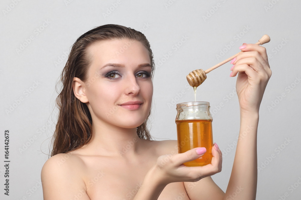 Fototapeta premium Beautiful woman with honey on her face