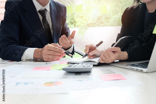 Financial planning Business man and Business woman talking to planner financial business, report finance in paper on office accounting desk.