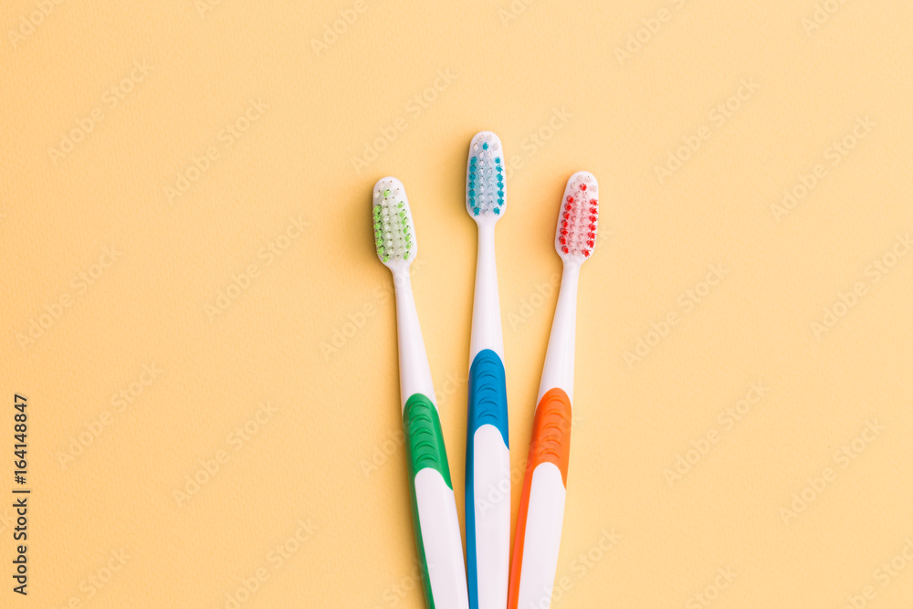 Toothbrushes on empty orange background Toothbrushes on empty orange background