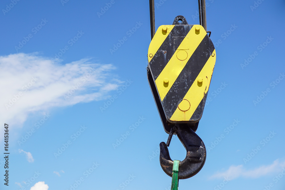Big yellow construction crane on blue sky background Big yellow construction crane on blue sky background