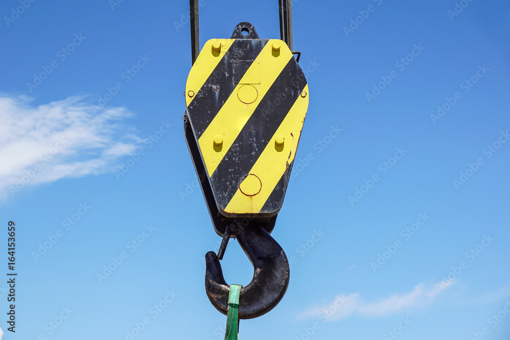 Big yellow construction crane on blue sky background Big yellow construction crane on blue sky background