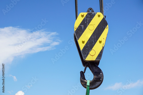 Big yellow construction crane on blue sky background