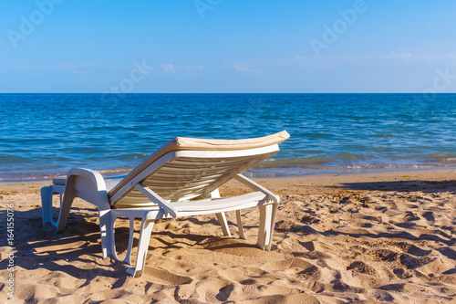 White sunbed on the sand beach at the sea, summer sea rest concept © O.Farion
