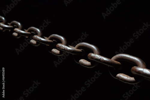 Steel chain spotlighted punctual diary lights on black background.