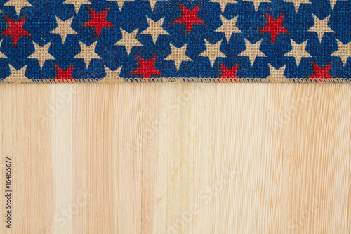 Red and blue stars burlap ribbon on wood background