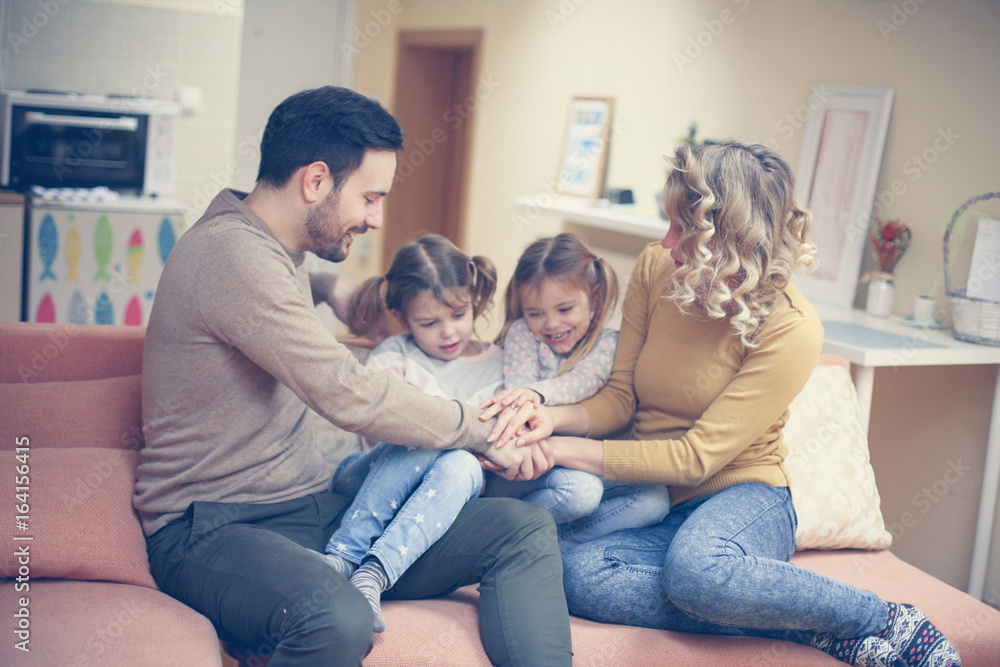 Portrait of family having fun in the living room. Happy family spending time at home together. Portrait of family having fun in the living room. Happy family spending time at home together.