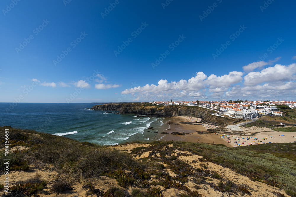 The fishing village of Zambujeira do Mar and its beach in the Vincentine Coast, Alentejo, Portugal; Concept for travel in Portugal and summer vacations