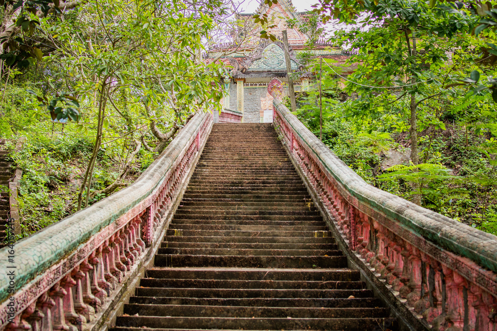 Fototapeta premium Stairway going up to the buddhist temple in jungle forest