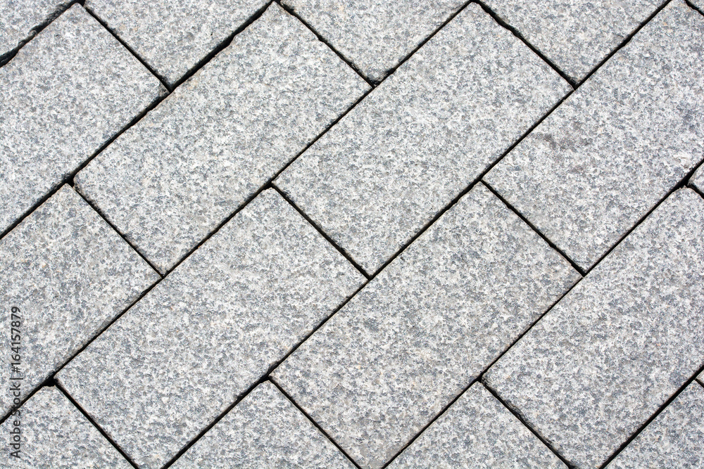 The area, laid out of paving stone. Background texture relief. The area, laid out of paving stone. Background texture relief.