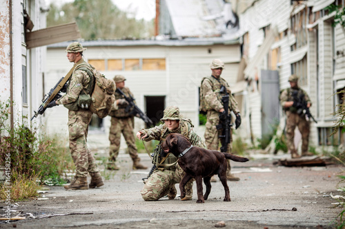 Soldiers on patrol in destroyed city. Military and rescue operation concept.