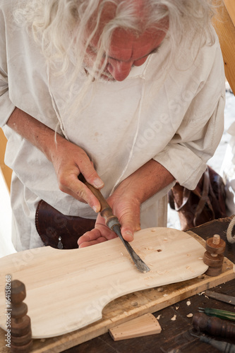 The luthier builds a medieval stringed instrument