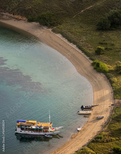 Tourist boats are parking at the empty beach.