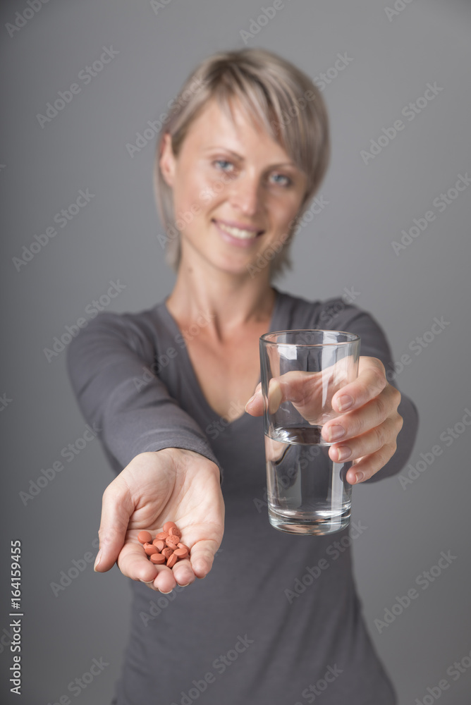 Beautiful lady holding a medicine pill in her hand Beautiful lady holding a medicine pill in her hand