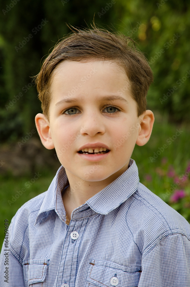 Head And Shoulders Portrait Of Boy Outside A House. Fashion photography. Head And Shoulders Portrait Of Boy Outside A House. Fashion photography.