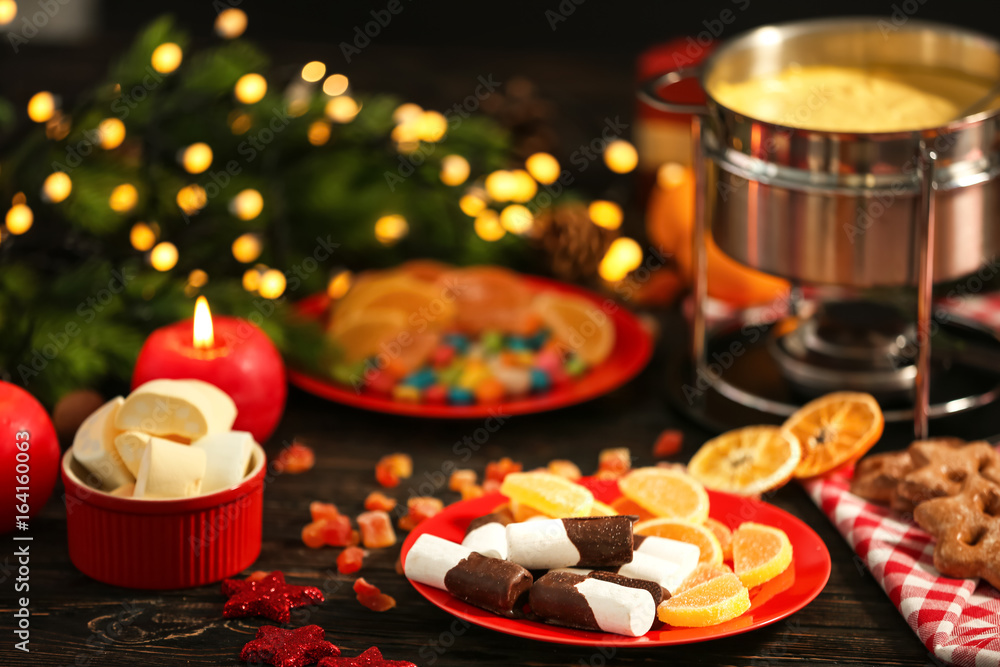 Beautiful composition with cheese fondue and sweets on table Beautiful composition with cheese fondue and sweets on table