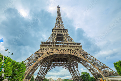 Prospective view of Tour Eiffel, symbol and icon of Paris. Paris Eiffel Tower lower panorama from bottom in Champ de Mars garden, from Paris in France. Europe travel concept.