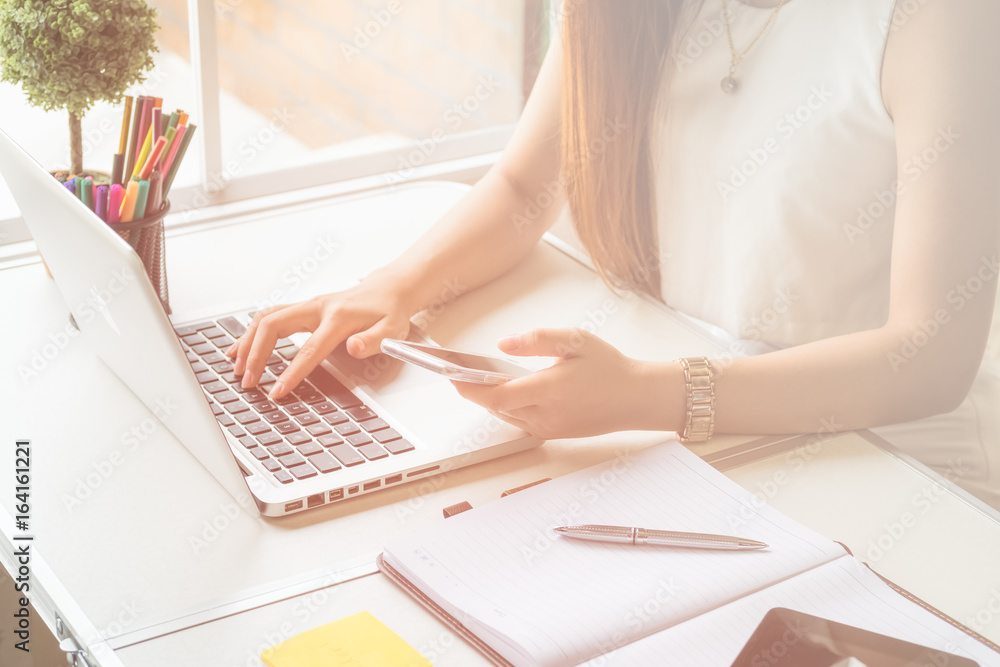 Fototapeta premium Young asian women entrepreneur working in a home office at her desk, Home work space concept
