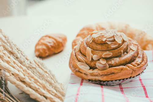 fresh bread and baked goods on wooden chopping board, rustic style