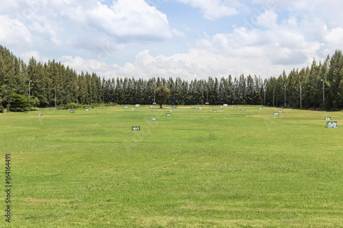 view of golf course yard signs for practicing golf driving range with blue sky