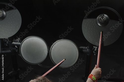 Unidentified Caucasian little girl play electronic drum