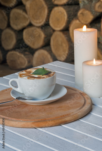 Coffee cup on bar table and romantic candles closeup
