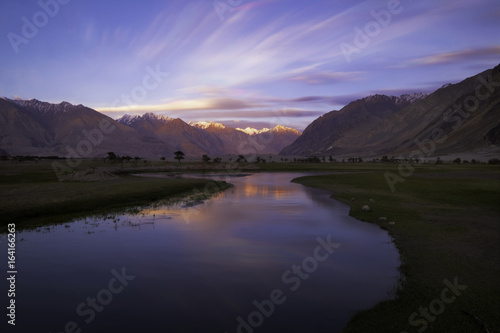 The reflection of mountain and a sunset at sand dune, Nubra valley, Leh Ladakh, India