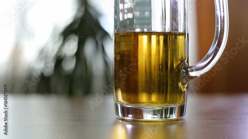 Half empty beer mug on table / Half empty beer mug on table indoors photo