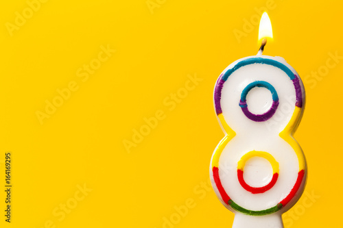 Canvas Print Number 8 birthday celebration candle against a bright yellow background