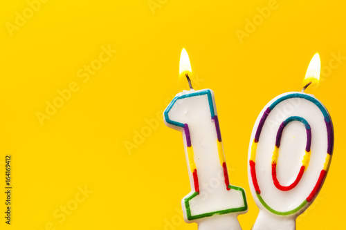 Canvas Print Number 10 birthday celebration candle against a bright yellow background