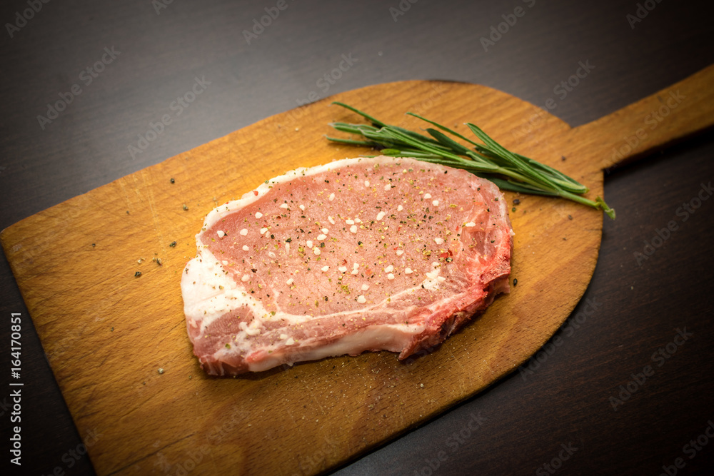 Raw pork with salt pepper and rosmary Raw pork with salt pepper and rosmary