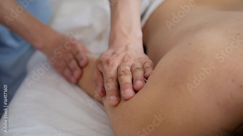 Masseur doing massage on hand