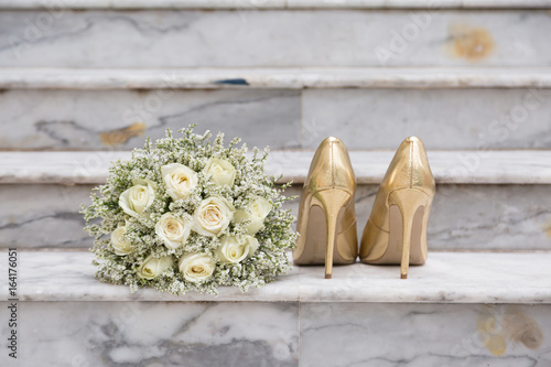 White Rose Bouquet and Gold Wedding Shoes on Marble Steps