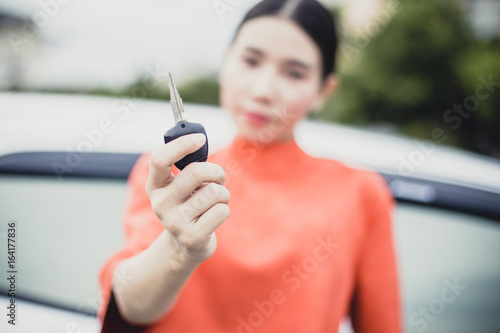 Close-up of woman hand holding car key. Woman using car key. © Bavorndej