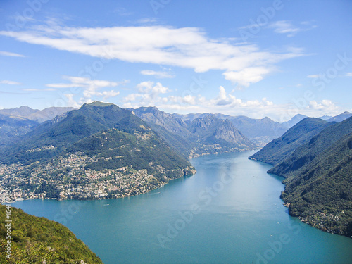 Aerial view of Lugano city with houses, lake and cityscape, and alpine Swiss mountains © Andriy Blokhin