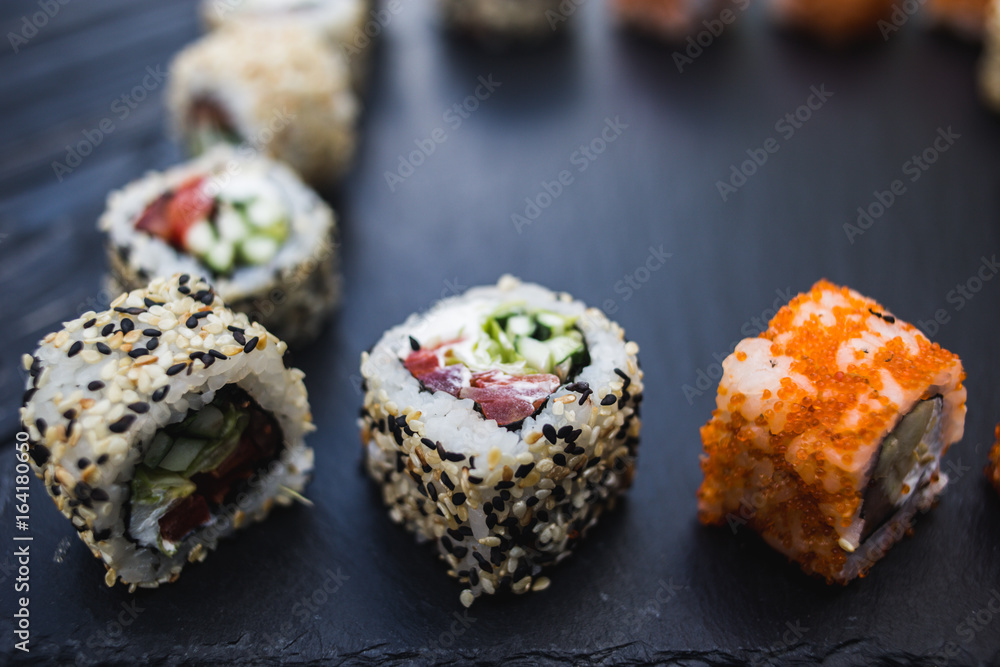 Japanese sushi on a rustic dark background Japanese sushi on a rustic dark background